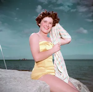 Swimming Prints: Portrait of a young woman in a swimsuit by the sea