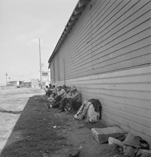 Possibly: Idle men seated in shade on the other side... Tulelake, Siskiyou County, California, 1939 Creator: Dorothea Lange