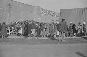 Possibly: Negroes at mealtime in the flood refugee camp, Forrest City, Arkansas, 1937. Creator: Walker Evans