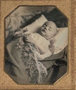 Infant Mortality Prints: Postmortem Baby, Partially Covered by a Flowered Shawl with a Fringe Hem, 1840s