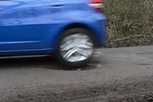 Pot holes in road surface 2017. Creator: Unknown