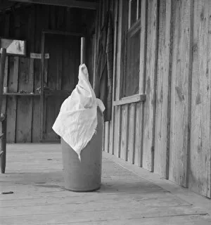 Porch Gallery: Pottery butter churn on porch of Negro tenant... Randolph County, North Carolina, 1939