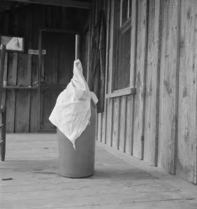 Butter Churn Collection: Pottery butter churn on porch of Negro tenant... Randolph County, North Carolina, 1939