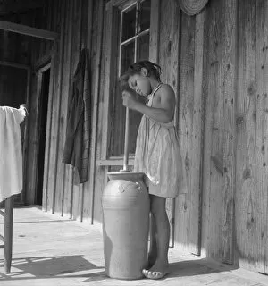 Pottery butter churn on porch of Negro tenant family, Randolph County, N Carolina, 1939. Creator: Dorothea Lange