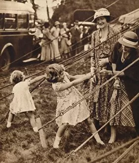 King George V Gallery: Princess Elizabeth and Princess Margaret pull their weight, 1930s (1935)