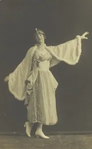 Prisoners Of War Prints: A prisoner of war in drag, wearing a dress and white cloak