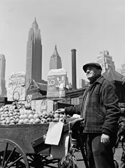 Push cart fruit vendor at the Fulton fish market, New York, 1943. Creator: Gordon Parks