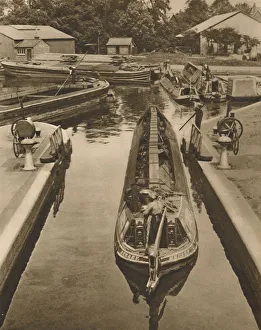 Narrow Boat Prints: Pushing a Monkey Boat Through The Lock at Brentford, c1935. Creator: Unknown