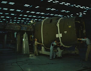 Putting the nose section of a mighty transport...Consolidated Aircraft... Fort Worth, Texas, 1942