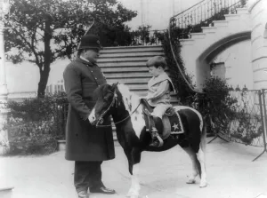 Bodyguard Prints: Quentin Roosevelt on pony beside White House policeman