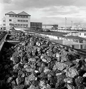 Rail trucks loaded with coal leaving Lynemouth Colliery, Northumberland, 1963. Artist
