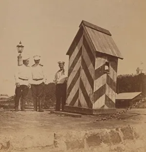 Expatriate Prints: By the railway, three men in uniform standing near a guard booth