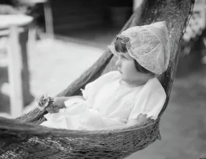 Grandchildren Prints: Rice, Isaac, Mrs. grandaughter of, in a hammock, 1920 July 26. Creator: Arnold Genthe