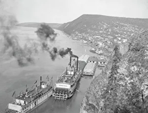 River Boat Prints: Riverboats distant view of town, between c1900 and 1923. Creator: Unknown