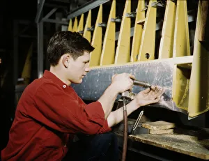 Assembly Line Methods Collection: Riveter at work at the Douglas Aircraft Corporation plant in Long Beach, Calif. 1942