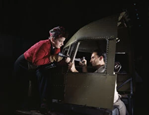 Assembly Line Gallery: Riveting team working on the cockpit shell of a...Douglas Aircraft Co. Long Beach, Calif. 1942