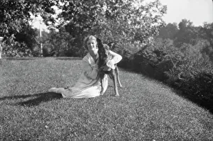 Portrait Photographs Prints: Robins, Miss, with dog, outdoors, 1918 Feb. 16. Creator: Arnold Genthe