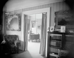 Bookcase Prints: Room with bookcase, study with desk, between 1900 and 1915. Creator: Unknown