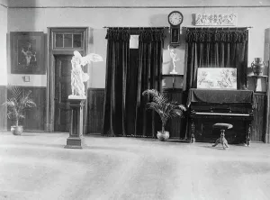 Frieze Prints: Room with piano, potted palms, and classical statues and friezes