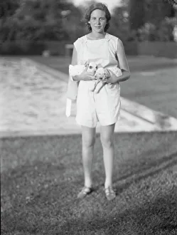 Portrait Photographs Prints: Rossbach, Miss, holding puppies, standing outdoors, 1932 June 30. Creator: Arnold Genthe