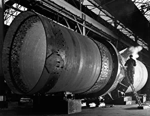 Steelworker Prints: A rotary kiln section being welded in preparation for installation