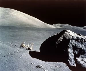 Shoot for the Moon Collection: The Rover is dwarfed by a giant rock on the lunar surface, Apollo 17 mission, December 1972