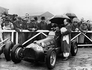 Umbrella Prints: RRA Supercharged Special, G. N. Richardson in paddock at Aintree 1954. Creator: Unknown