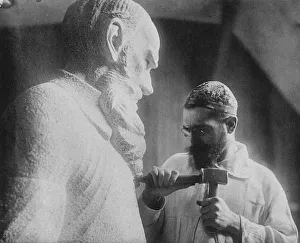 Portraitb W Prints: Russian sculptor Sergey Merkurov (1881-1952) working on his statue of Leo Tolstoy Artist: Anonymous