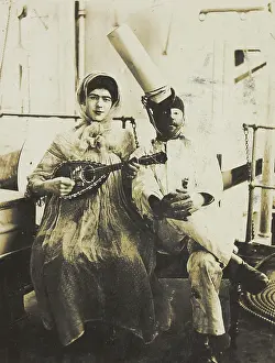 Mandolin Prints: Two sailors (?) on board ship: one in drag is playing a guitar, 1907. Creator: Unknown