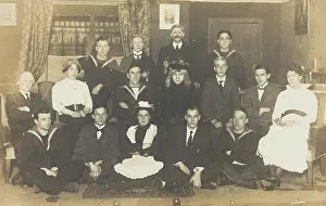Legs Crossed Prints: Sailors, some in drag, posing for a group portrait within a highly
