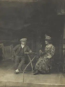 Check Prints: Two sailors, one in drag, sit on stage at a table