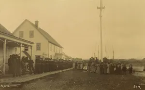 Observing Prints: Sailors standing in line on boardwalk with a group of local women and men standing