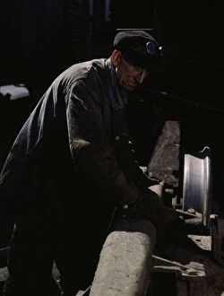 Chicago And North Western Railway Gallery: Sam Cell, working on the truck of a car... C & NW RRs Proviso yard, Chicago, Ill. 1943