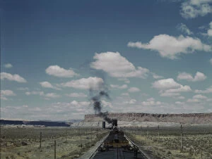 Atchison Topeka Santa Fe Railway Gallery: Santa Fe R.R. train stopping for coal and water, Laguna, New Mexico, 1943. Creator: Jack Delano
