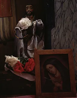 A Santo bulto and a painting of the Dolorosa in the church, Trampas, New Mexico, 1943. Creator: John Collier