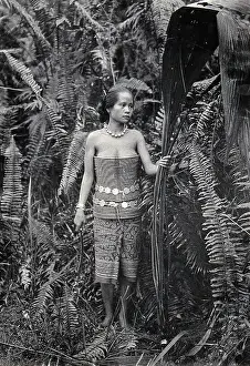 Fibre Prints: Sarawak: a girl picking leaves for use as fibres, c1900. Creator: Unknown