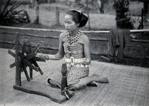 Fibre Prints: Sarawak: a girl spinning cotton into thread, c1900. Creator: Unknown