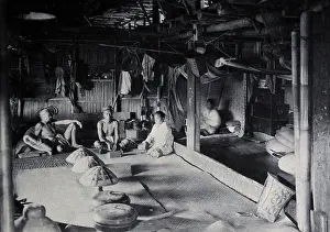 Southeast Asia Prints: Sarawak: interior of a Kadayan tribal house, with a meal laid out, c1900. Creator: Unknown