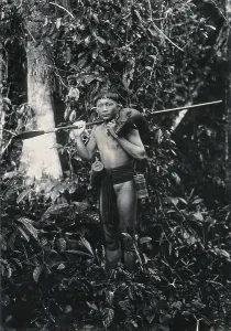 Jungle Prints: Sarawak: a Kenyah hunter with blowpipe and dead animal, c1900. Creator: Unknown