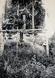 Crouching Prints: Sarawak: two Kenyah people boring a blowpipe, c1900. Creator: Unknown