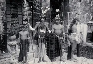 Sea Dayak Prints: Sarawak: Sea Dayaks with weapons and head-dresses, c1900. Creator: Unknown