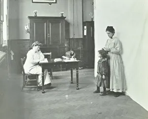 Bermondsey Prints: School nurse examining girls hair for head lice, Chaucer School, London, 1911