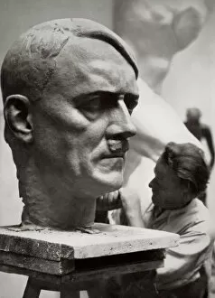 Adolf Hitler Collection: A sculptor working on a large portrait bust of Adolf Hitler, Germany, 1936. Artist