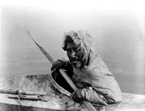 Kayak Prints: The seal-hunter, Noatak, in kayak, facing left, c1929. Creator: Edward Sheriff Curtis