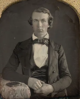 Daguerreotype Prints: Seated Young Man Resting Arm on Table Beside Daguerreotype Case, 1840s. Creator: Unknown
