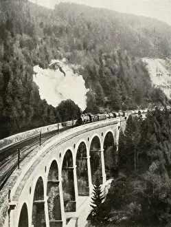Allen Gallery: In the Semmering Valley, Austria. A good train crossing the curved Gamperl Viaduct, 1935-36
