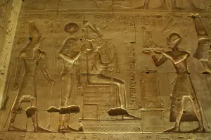 Seti I offering a statue of goddess Maat to gods Osiris... Temple of Seti I, Abydos, Egypt (2003). Creator: LTL