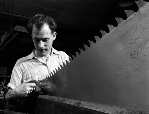Steelworker Prints: Setting the saw teeth a two metre saw blade, Sheffield, South Yorkshire, 1963. Artist