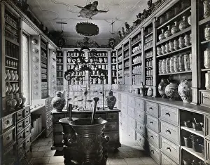 Mortar And Pestle Prints: A seventeenth-century German apothecary's shop with ornate pharmacy jars... c1900s
