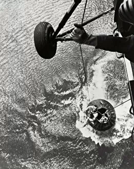 Shepard hoisted from Mercury capsule, 1961. Creator: NASA